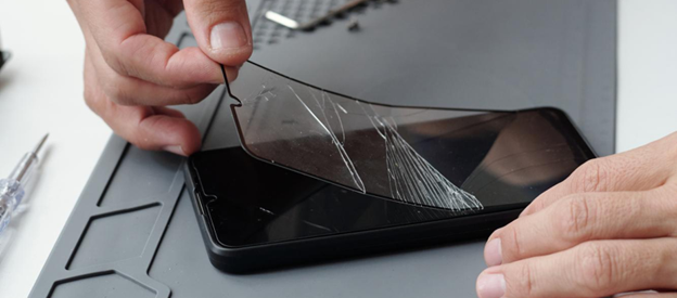Technician removing a cracked smartphone screen during a phone repair in Melbourne