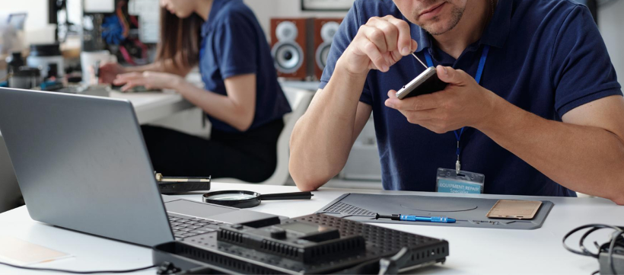 Phone and Laptop Repair Services AMT Electronics-img2 Technician repairing a smartphone at an electronics repair workstation in Melbourne