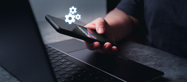 Phone and Laptop Repair Services AMT Electronics-img3 Person using a smartphone and laptop while receiving software updates in Melbourne
