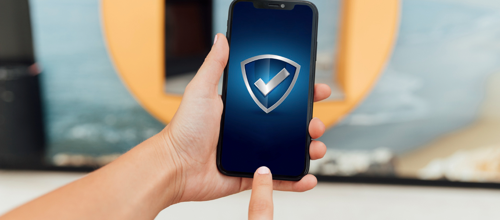Used iPhone Verification AMT Electronics Hand holding a smartphone displaying a security shield in Melbourne
